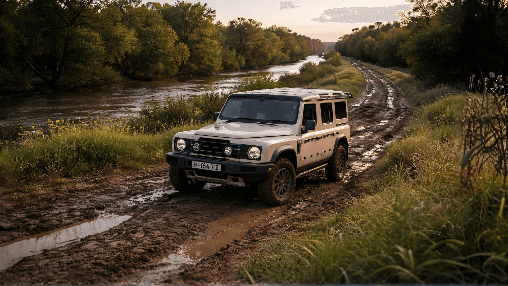 INEOS Grenadier driving on a muddy dirt levee road along the Cosumnes River near Elk Grove, California
