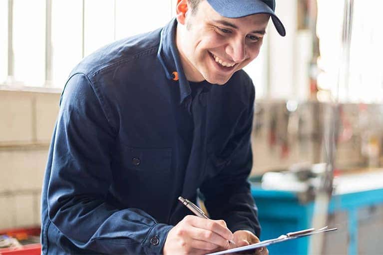 Mechanic Checking Vehicle Inspection Checklist