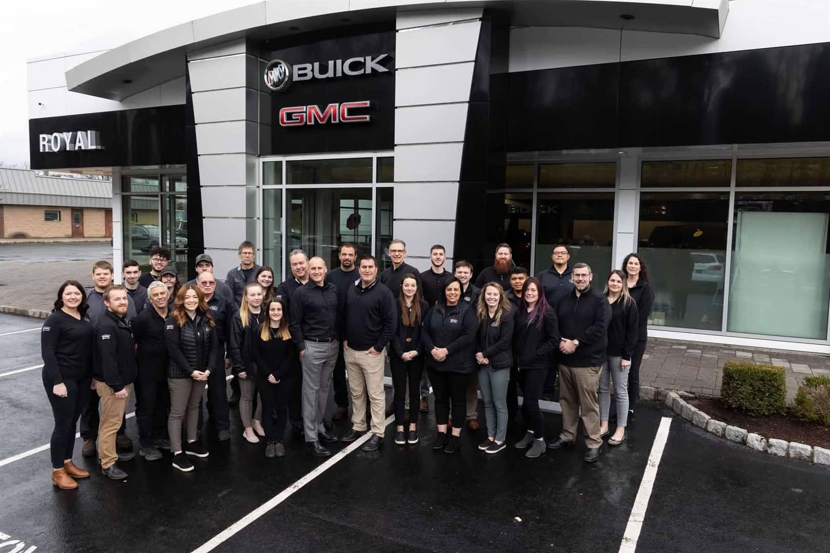 Royal-Buick-GMC-Staff-standing-outside-of-dealership-storefront