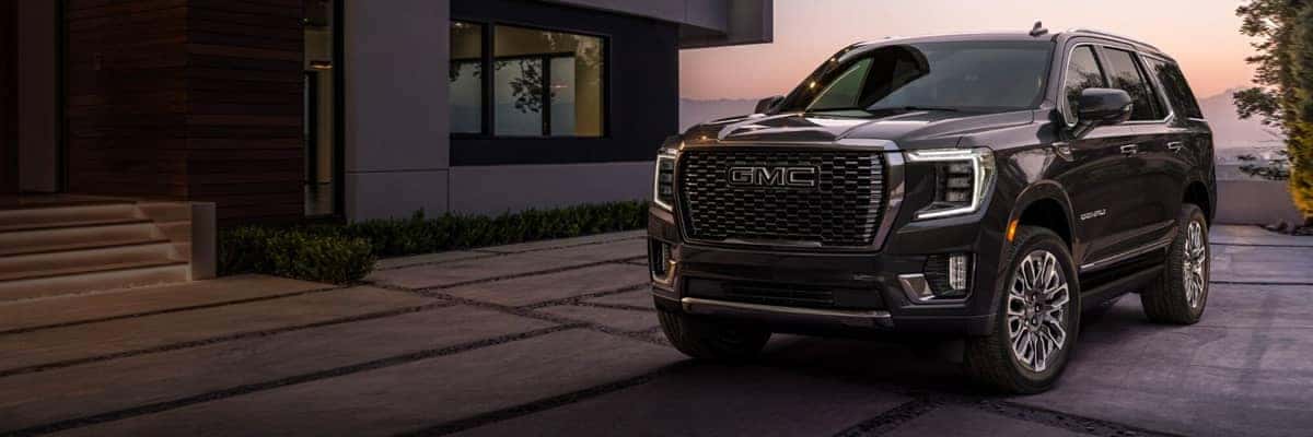 GMC Yukon Parked outside of house with sun setting