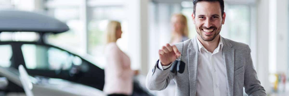 Salesperson handing over the keys to a customer
