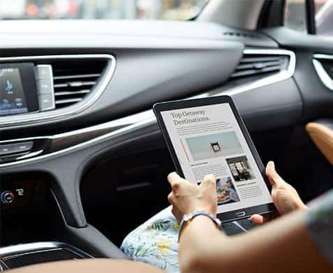 person using tablet in Buick 