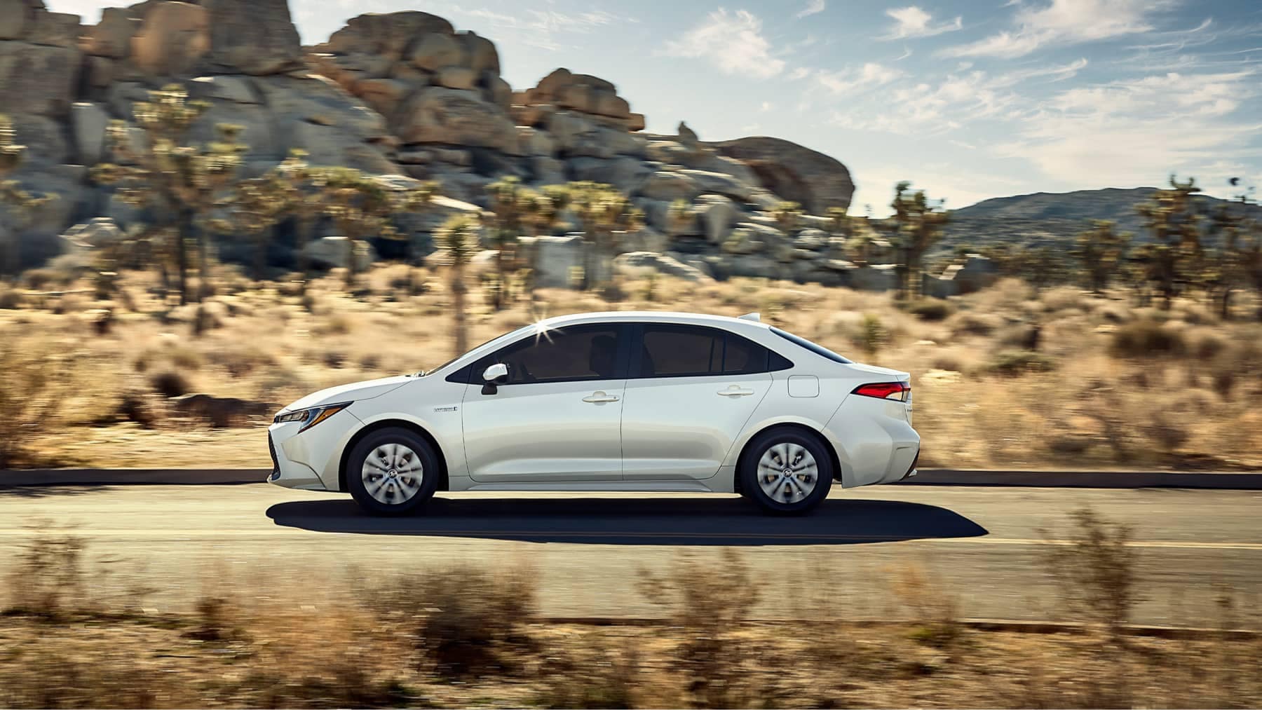 2021 Toyota Corolla speeding through a desert landscape