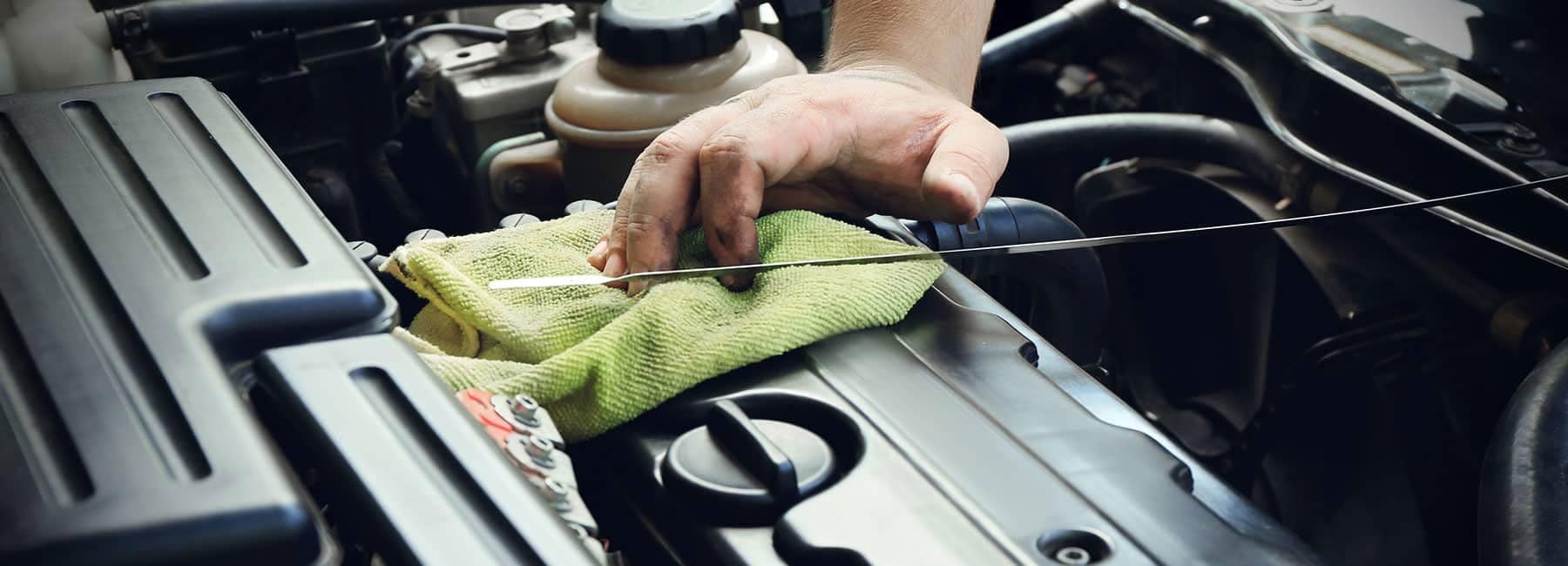 Auto mechanic changing the oil of a vehicle