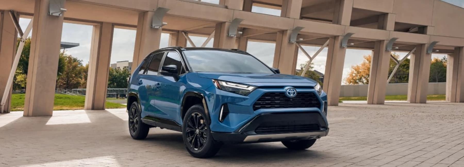 2022 Toyota RAV4 Hybrid front view parked in front of an aqueduct structure