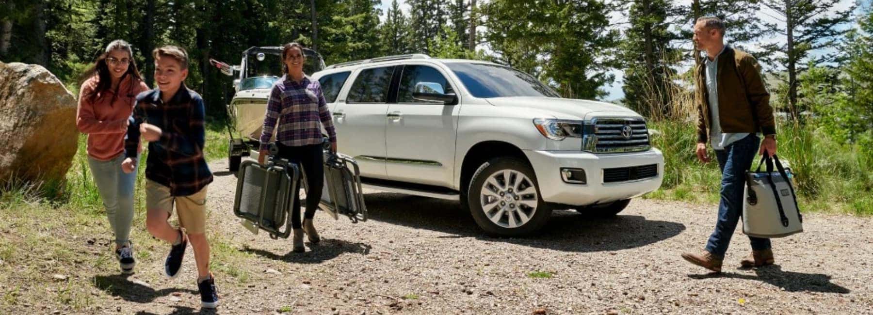 2022 Toyota Sequoia side view with a family unpacking a boat