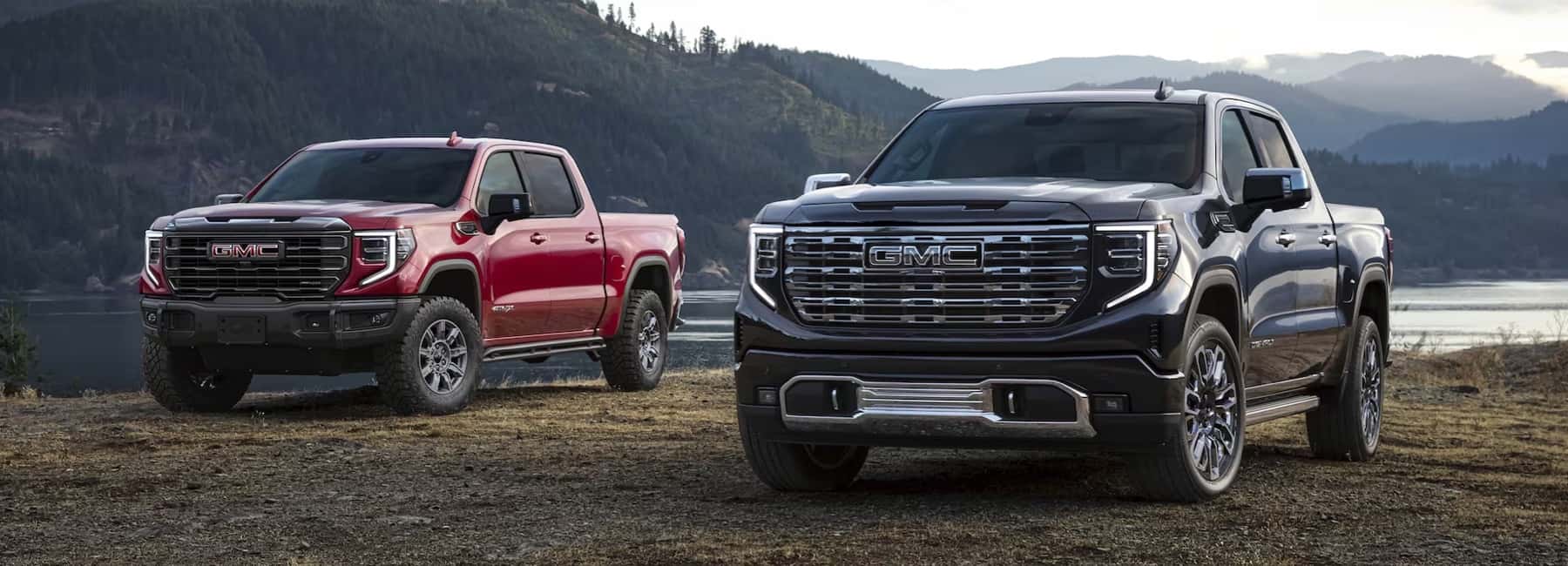 Silverado 1500 trucks parked by mountain lake
