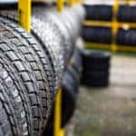 Rows of new tires on shelves in tire shop