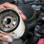 Mechanic's hand holding an oil filter