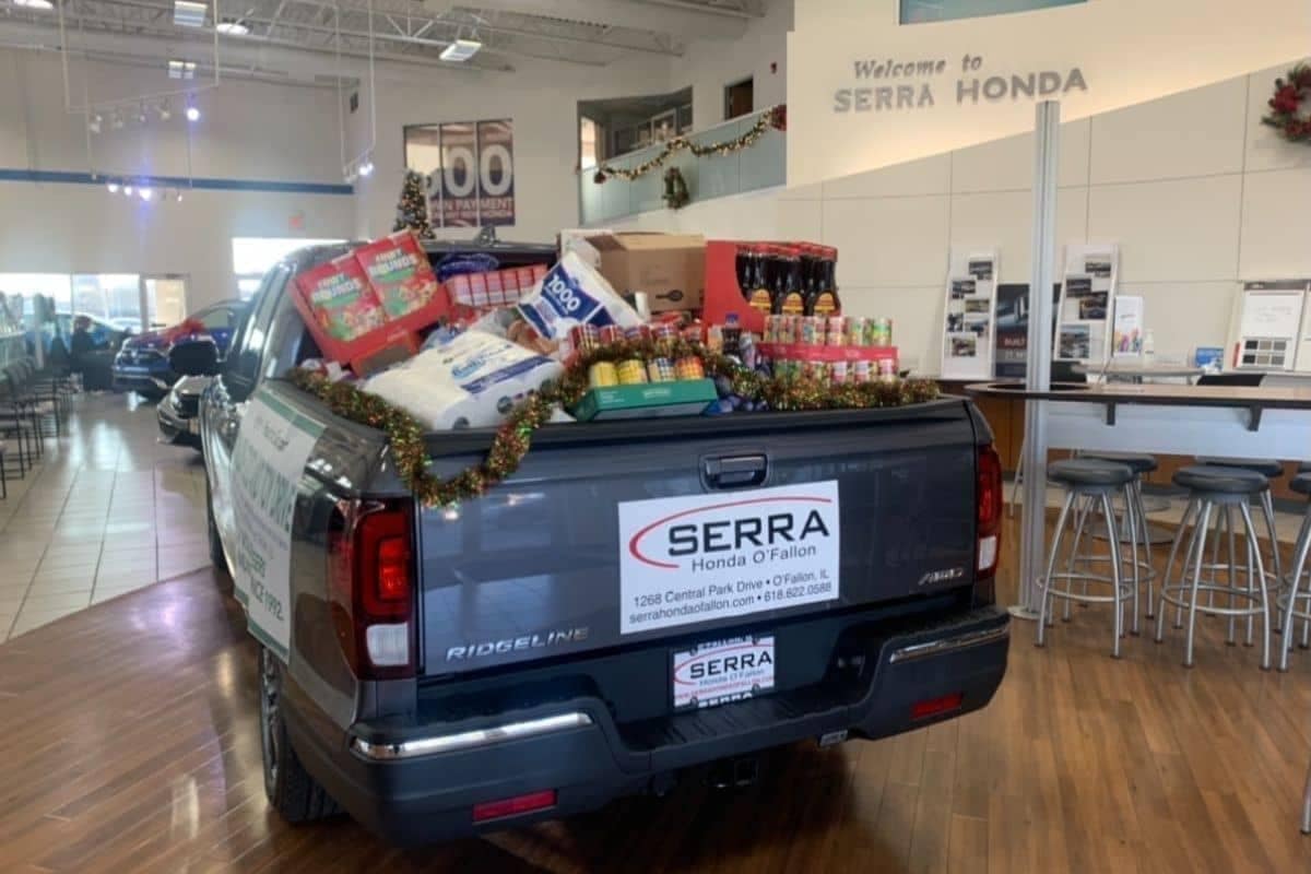 Honda Ridgeline with Serra Honda Logo on it with Bed Filled with food and other goods