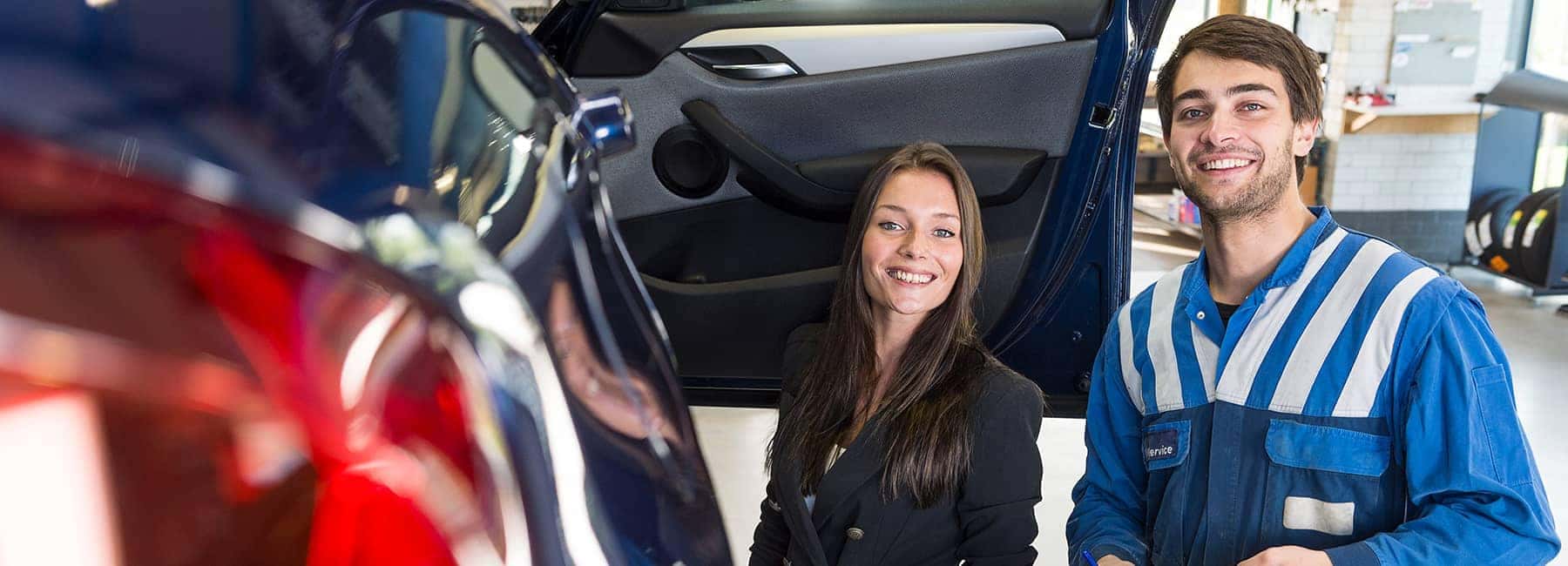 service-technician-shows-woman-her-car