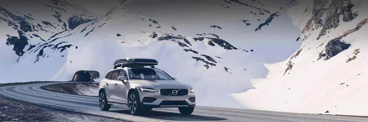 Volvo driving through snowy mountains