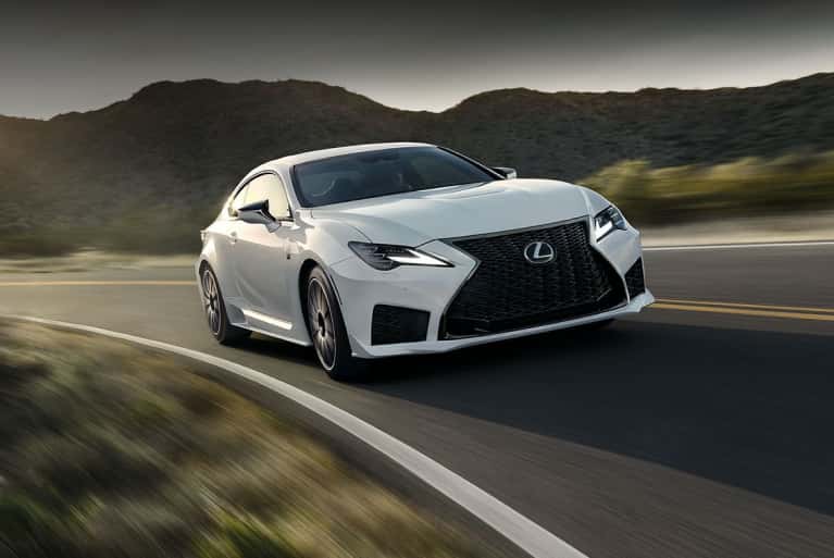 2024-Lexus-RCF-speeding-around-a-corner-with-the-sun-peaking-over-the-mountains-in-the-background-mobile