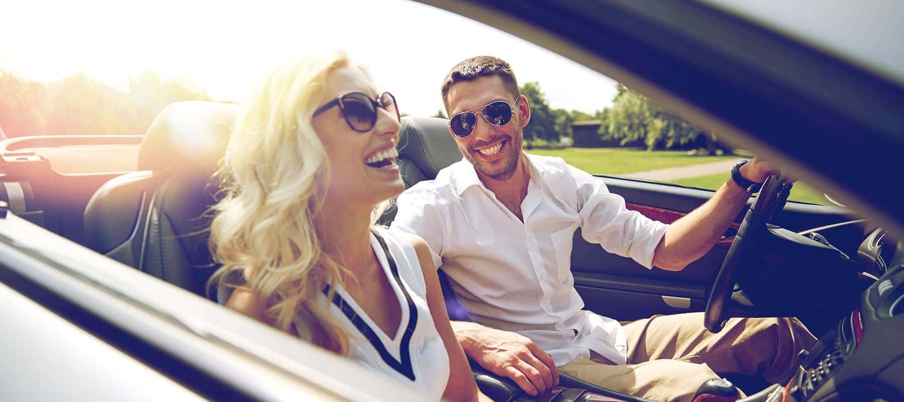 smiling couple in a convertible