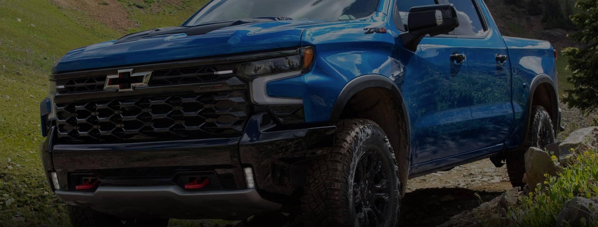 Blue Chevrolet truck driving off road