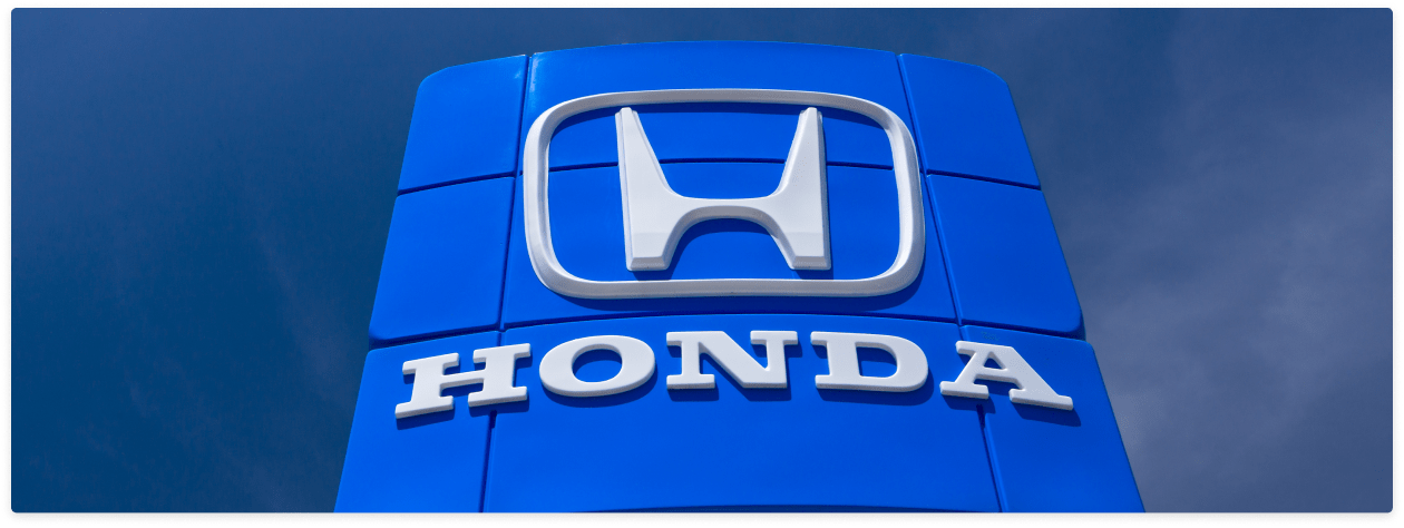 An exterior shot of a Honda dealership showcasing the Honda logo