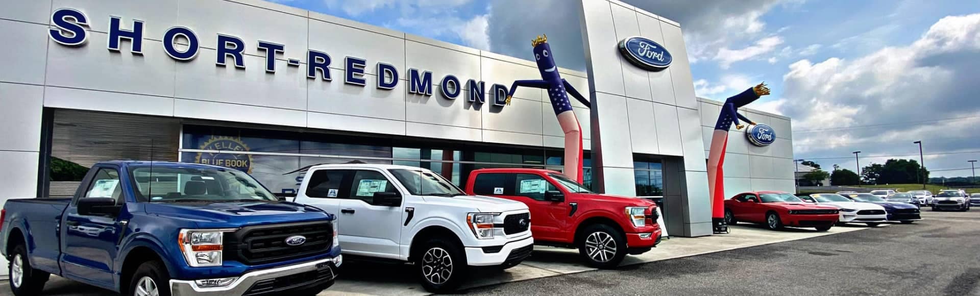 Short-Redmond Ford Dealership Exterior View with an American flag patterned whacky waving inflatable arm flailing tube man