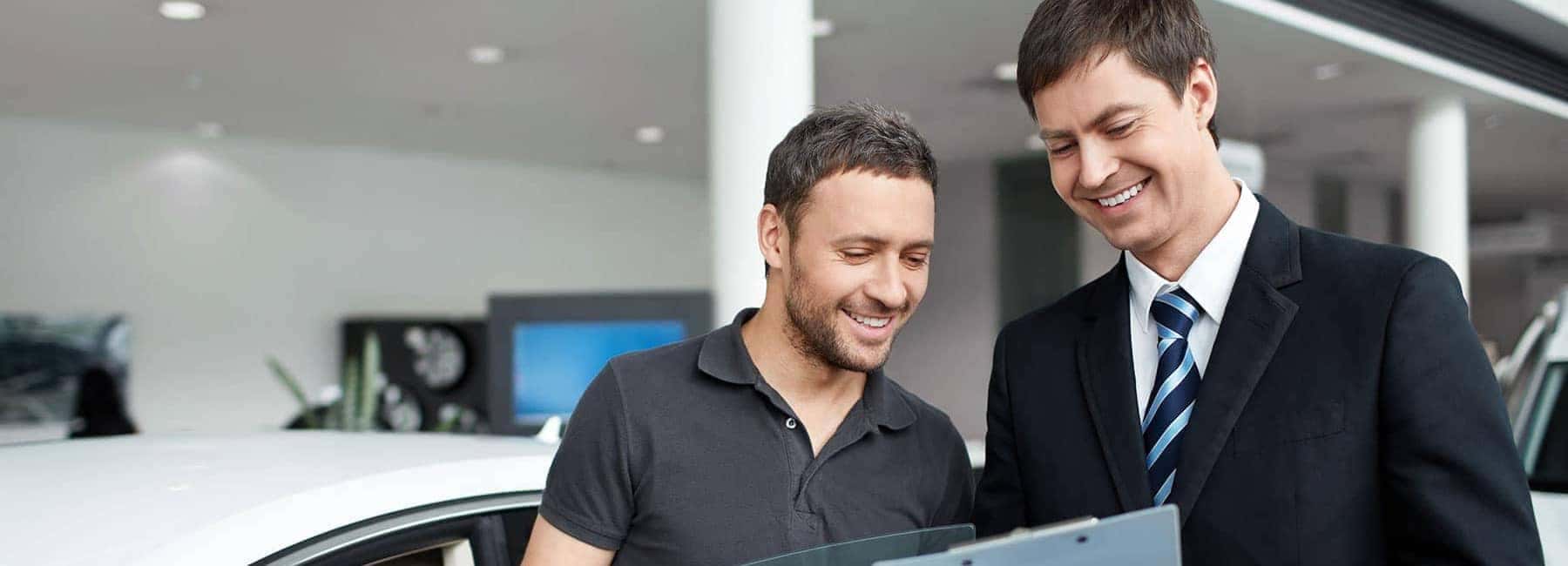 Man-Looking-at-Documents-with-Dealer