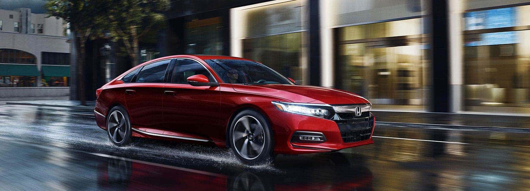 2019 Honda Accord speeds through wet city street