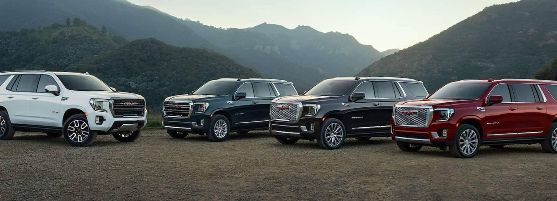 Group of 2023 GMC Yukon SUVs parked in mountains