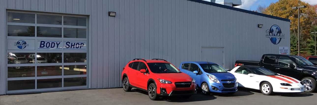 Cars are lined up by a collision shop