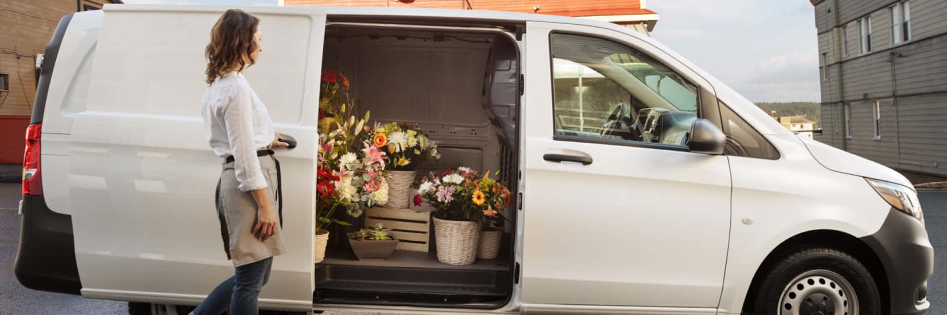 Women loading flowers into her Sprinter van.