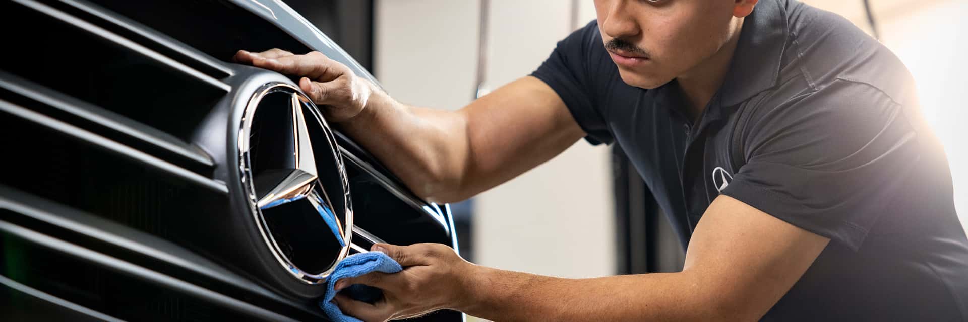 Mercedes-Benz Parts Tech cleaning the front of a Sprinter Van.