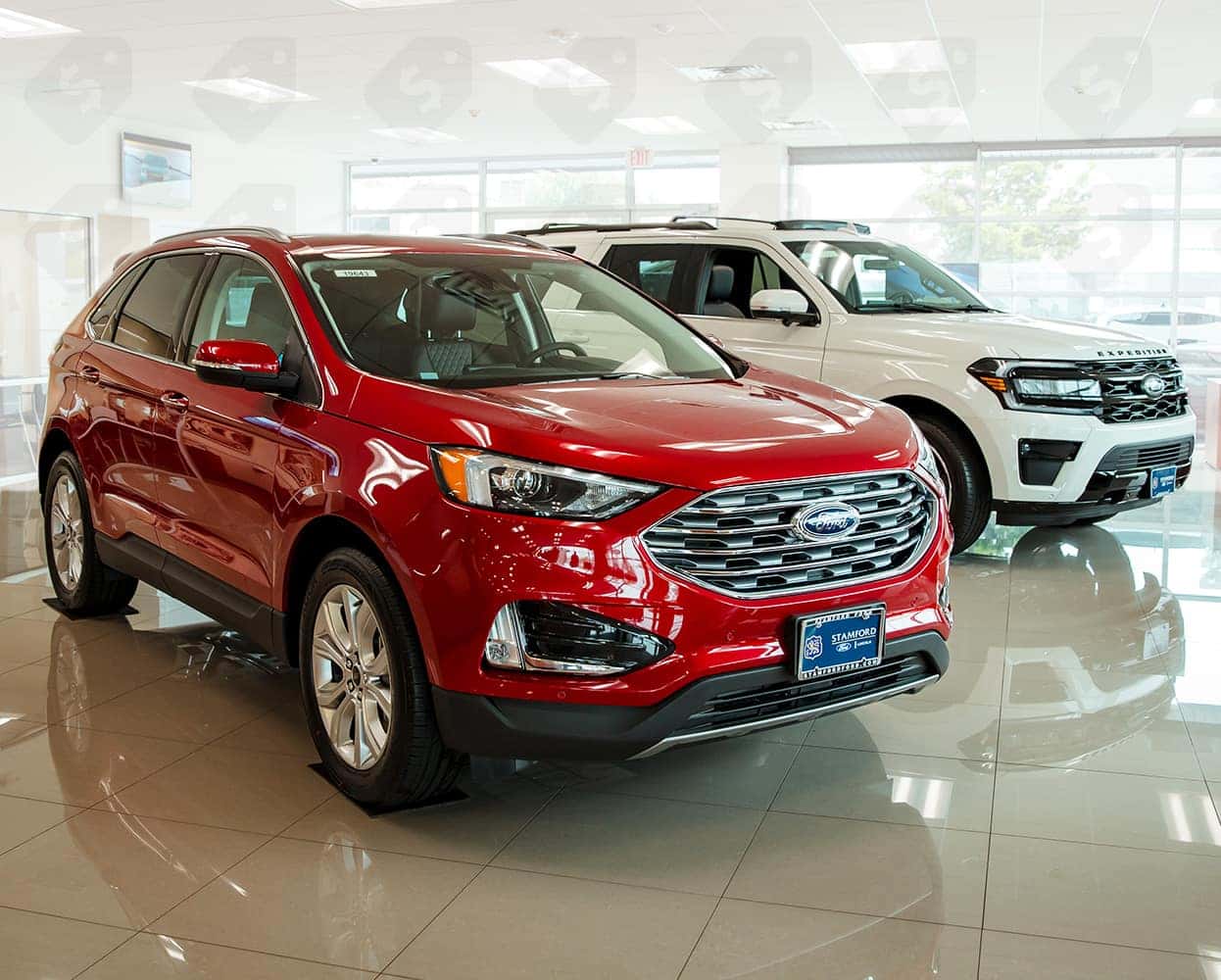 2 Ford suvs sitting in the showroom