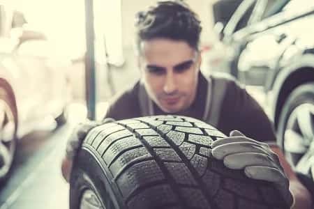 Man Checking Tire Tread Depth