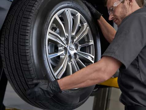 A Cadillac tire being serviced.