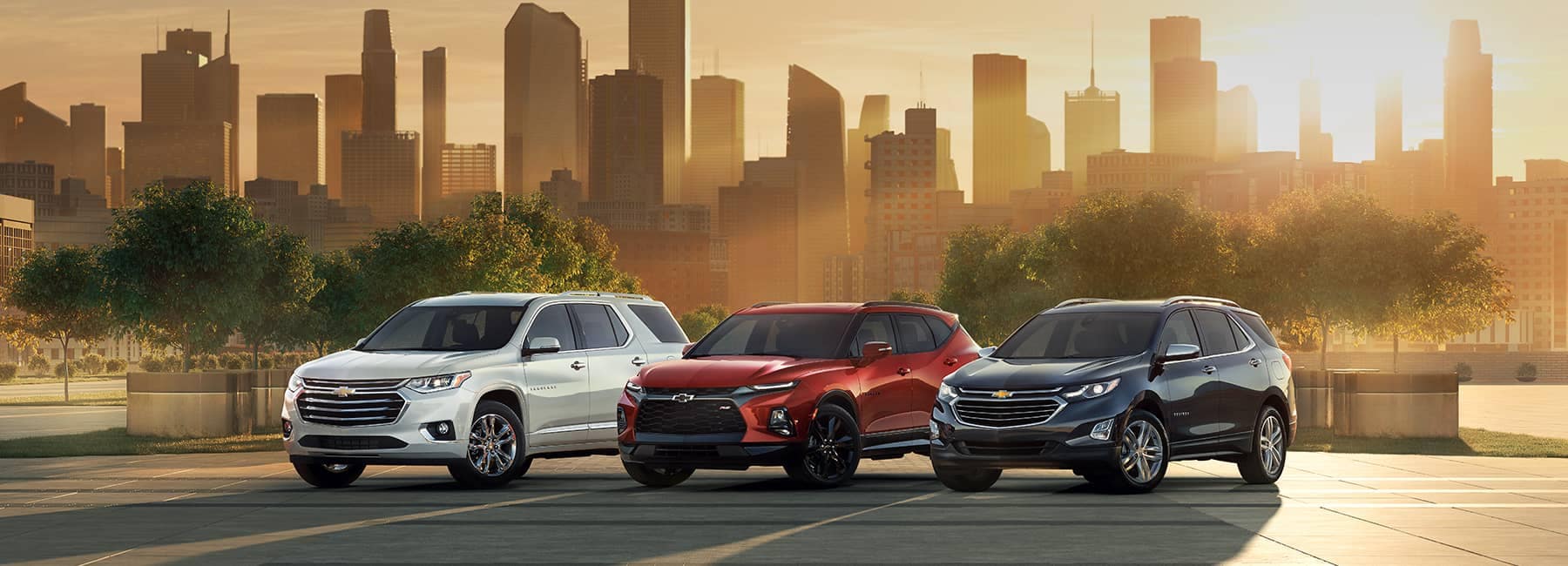 2020 Chevrolet Lineup Against a City Skyline at Sunset