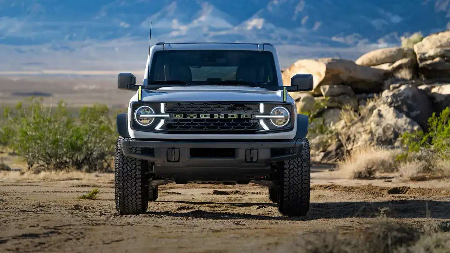 2026 Ford Bronco RTR From the front driving through a dirt road front grille