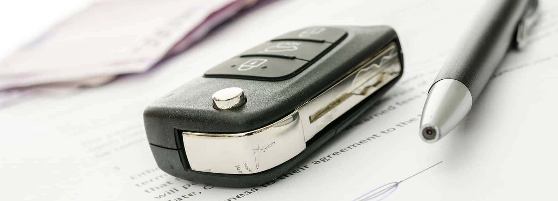 Car Key and Pen on Documents