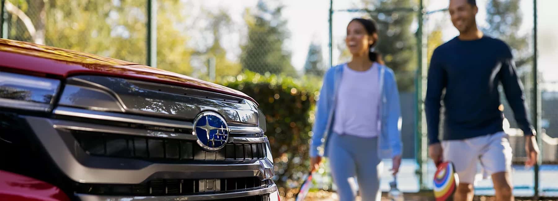 2025 red Forester with smiling couple