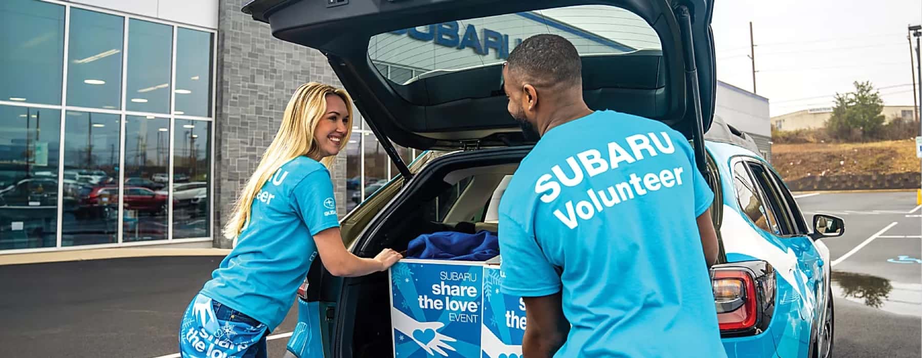 subaru volunteers pack donations