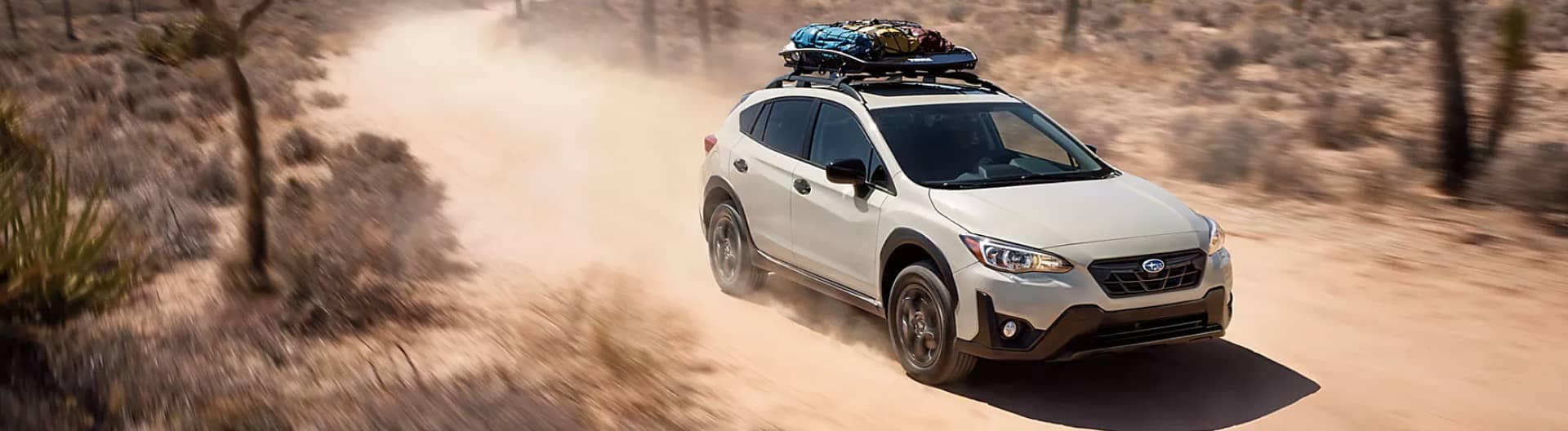 An exterior view of a Subaru Outback on a desert road