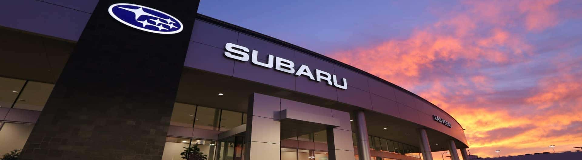 Exterior shot of Subaru of Las Vegas with the sunset in the background