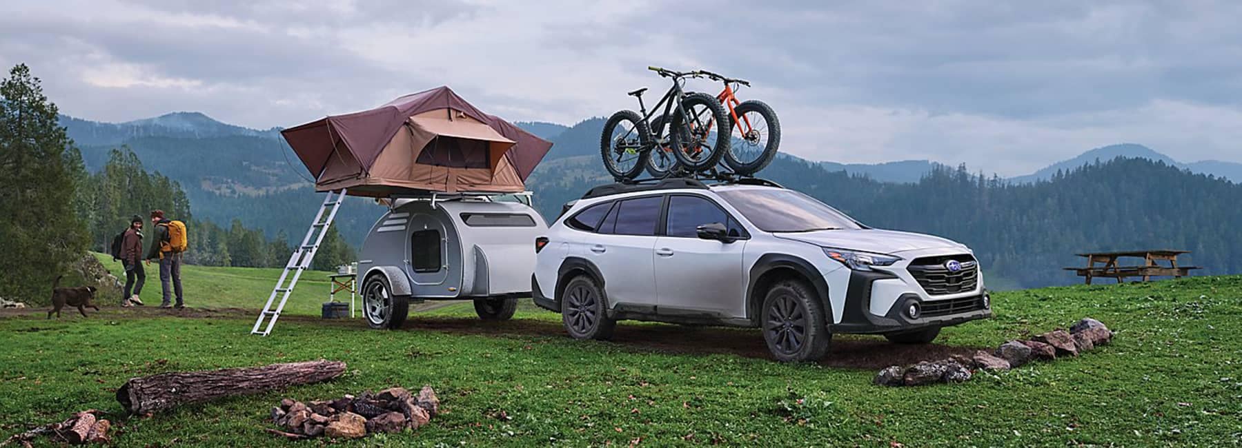 2023 Outback parked with camper and two bikes