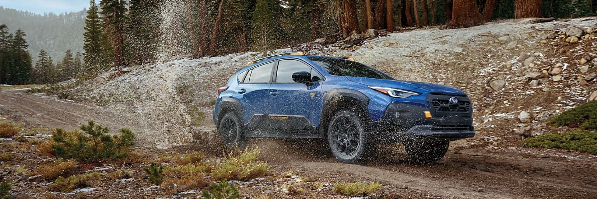 2024-Subaru-Crosstrek-driving-along-a-muddy-road