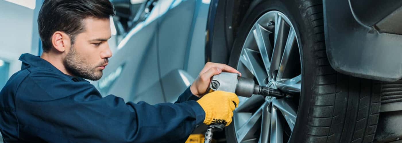 Service-Technician-working-on-a-tire