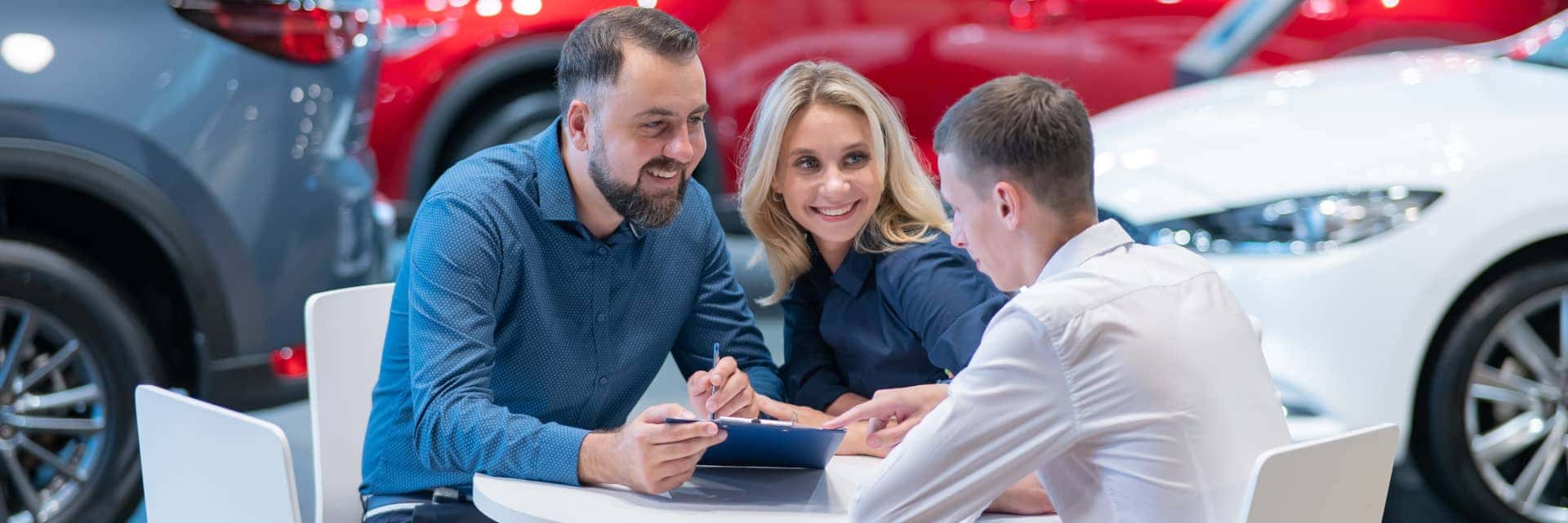 couple-signing-paper-work-with-finance-specialist