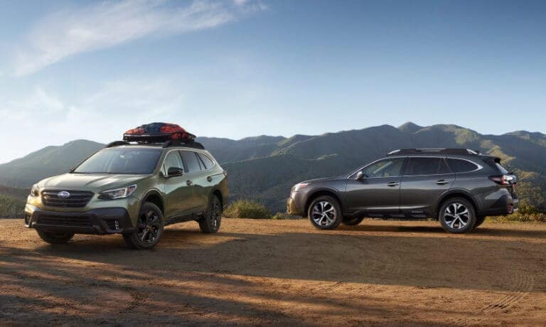 Two Subaru Outback Vehicles parked near a mountain