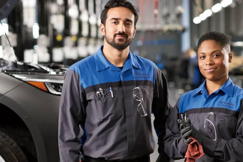 Two Subaru Service Technicians working on a Solterra