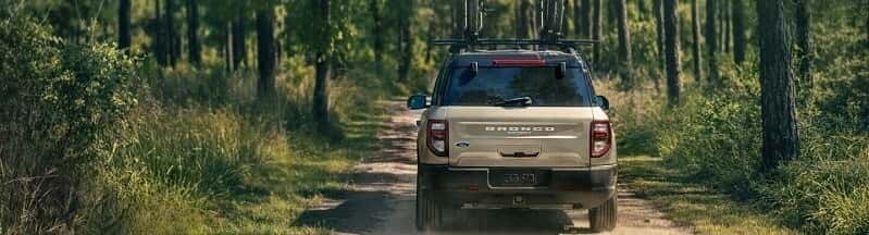 ford bronco sport driving up forest driveway