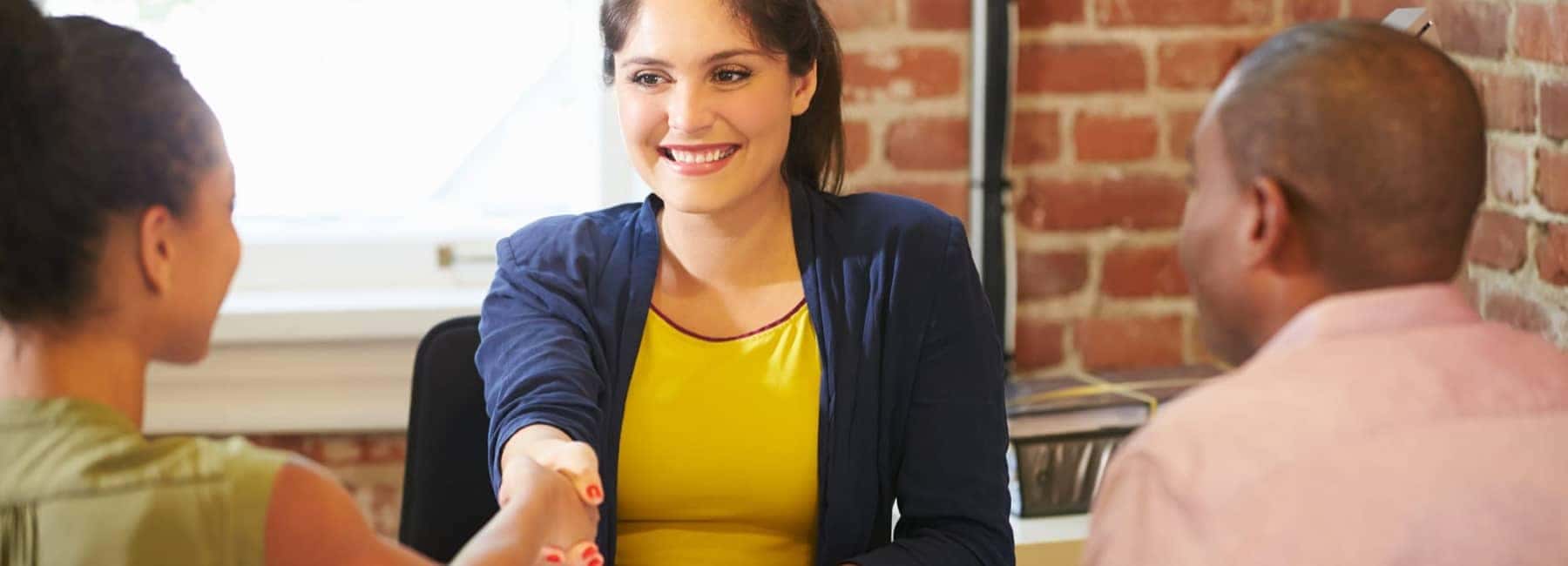 Woman Shaking Hands With A Young Girl Who Is With A Man