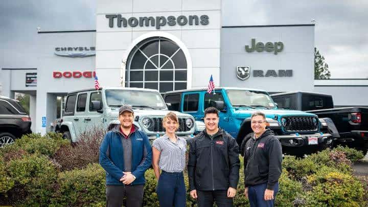 Thompsons dealership with smiling staff infront