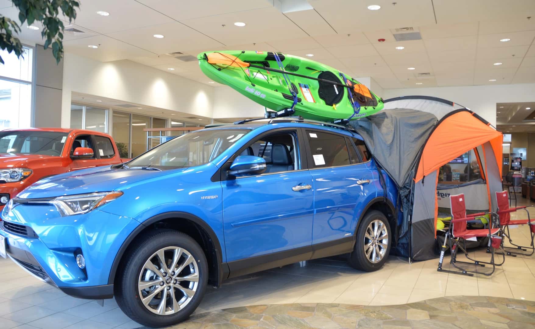 new Toyota in car showroom with Kayak on rooftop