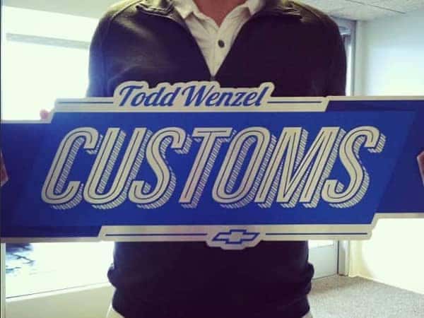 ToddWenzel-Customs- someone holding the Todd Wenzel Customs sign