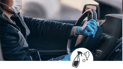 a-person-driving-a-car-wearing-a-mask-and-gloves