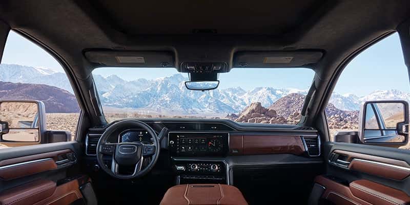 Interior of a 2024 GMC Sierra HD pickup truck overlooking a mountain range. - Toliver Brothers GM Ballinger, TX